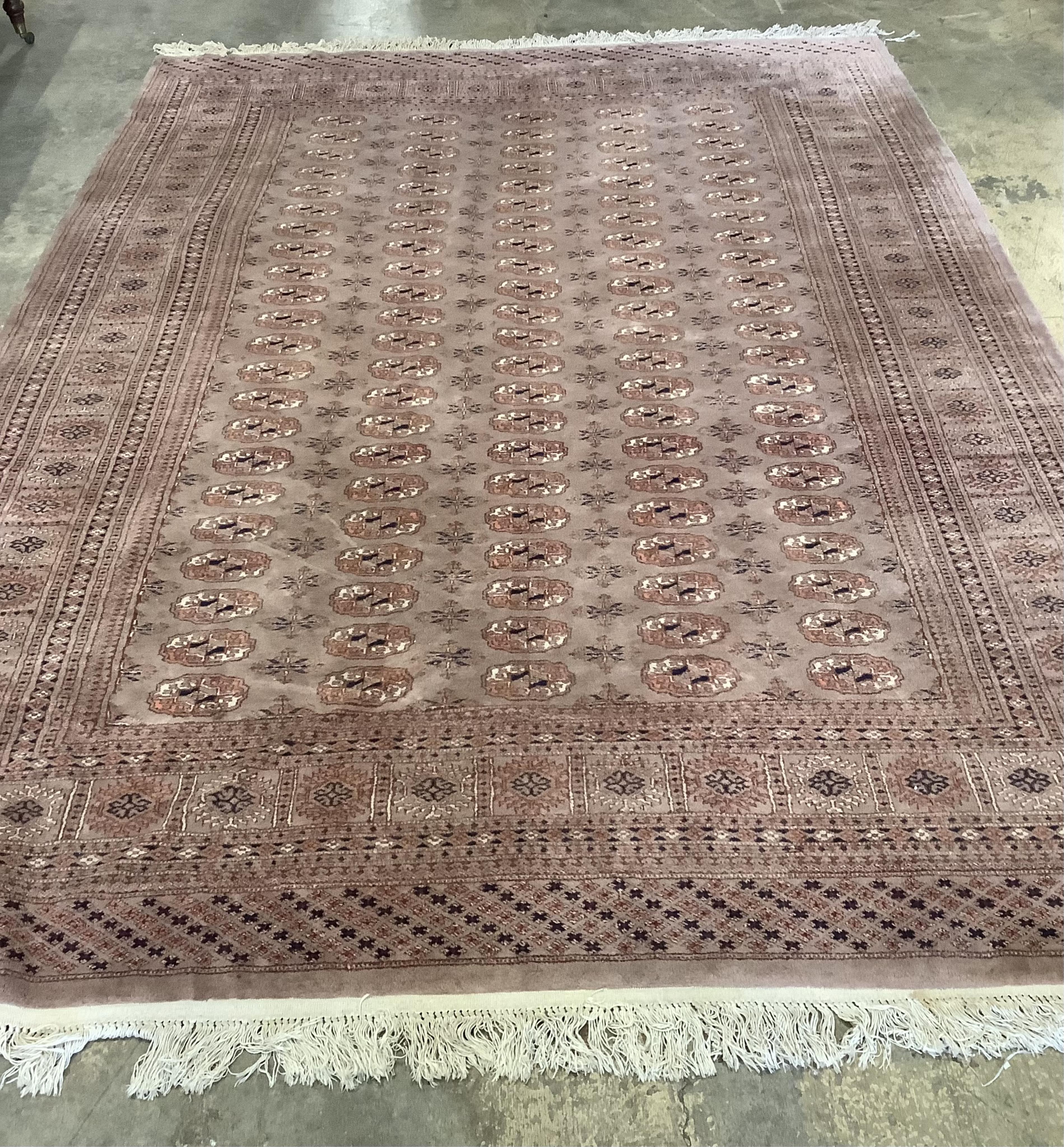 A Bokhara peach ground carpet, 320 x 215cm. Condition - poor to fair